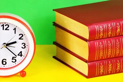 Books are a source of knowledge and clocks are a symbol of time Stock-Fotos