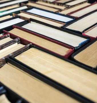 The books are stacked on the table. Background from book volumes. Reading and Stock Photos