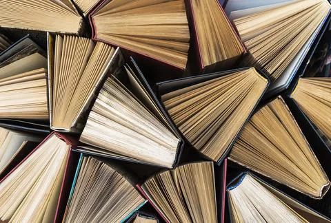 The books are stacked on the table. Background from book volumes. Reading and Stock Photos