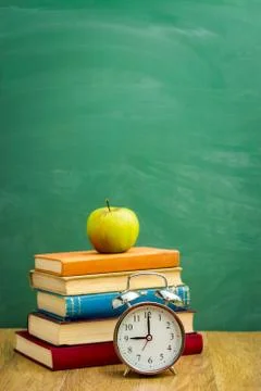 Books on the background of the school board Stock Photos