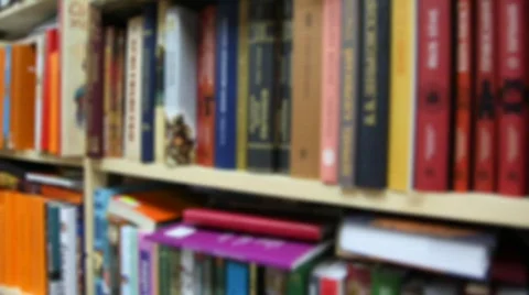 Books on bookshelfs in bookshop, vertical panning Stock Footage