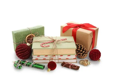 Books with candy cane, gift boxes and Christmas balls on white background Stock Photos