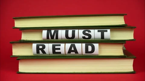 Books come into the frame and appears phrase MUST READ. Red background. StopMo Видео 326069930