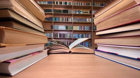 Books on desk in library, wind turning pages Stock Footage 182996982