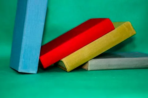Books on a green background. Stock Photos