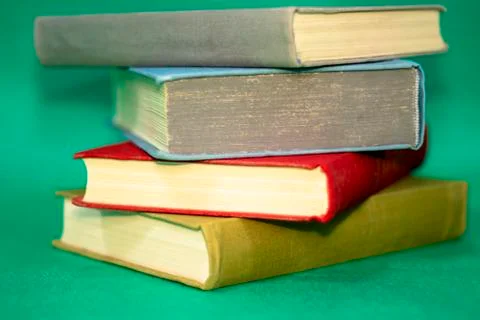 Books on a green background. Stock Photos