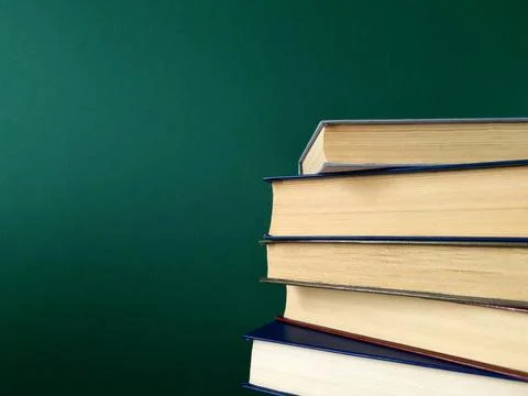 Books on a green background Stock Photos