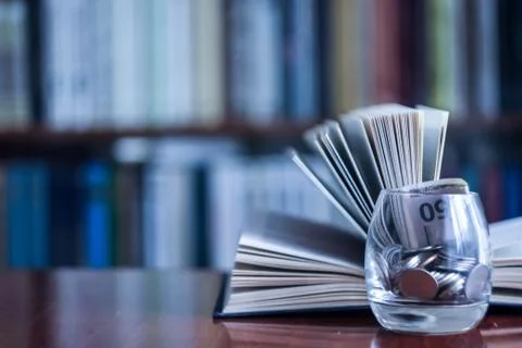 The books in the library on the table.To gain knowledge from the Stock Photos
