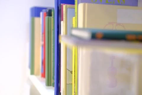 Books of multi-colored thin books of different sizes, similar to children's b Stock Photos
