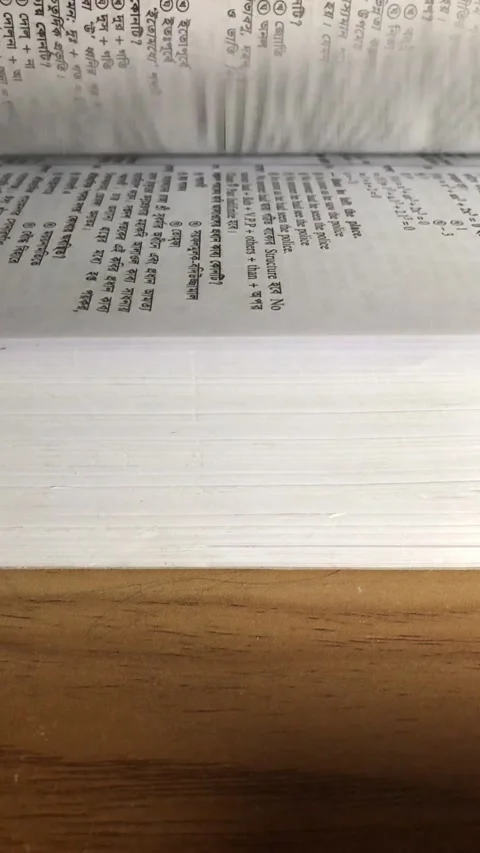 Book's page-turning on the table Stock Footage 169044925
