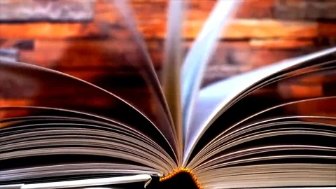 Book's pages turning by wind on table Stock Footage 84950358