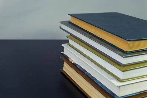 Books in a pile on a table Stock Photos