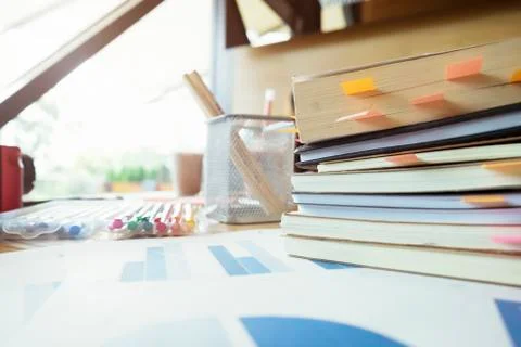 Books with post-it bookmarks on working table. Stock Photos