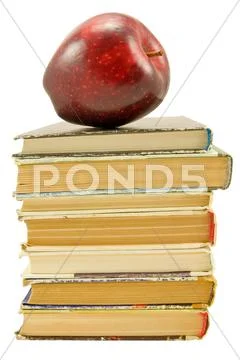 Books with red apple over white Stock Photos