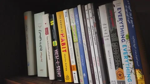 Books on the shelf Video stock 132631222