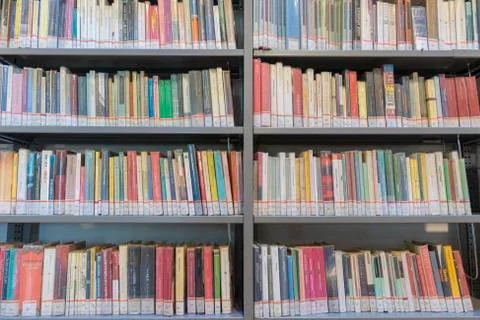 Books on the shelf in a public library, bound, to be used as a background Stock Photos
