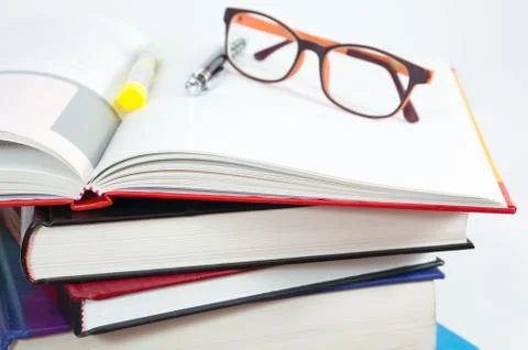 Books stack with open book and glasses Stock Photos