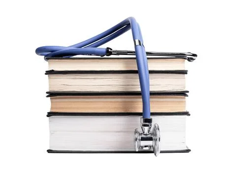Books stack with stethoscope isolated on white background. Medical education Stock Photos