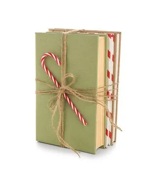 Books tied with string and candy cane on white background. Christmas celebrat Stock Photos