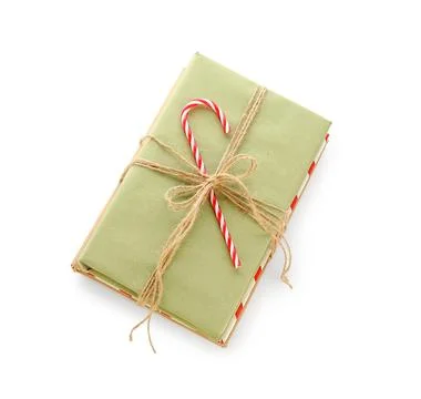 Books tied with string and candy cane on white background. Christmas celebrat Stock Photos