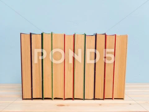 Books on a wooden shelf Stock Photos