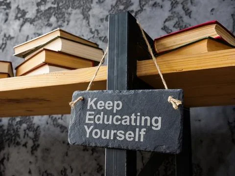 Bookshelf with the phrase keep educating yourself symbolizing lifelong lear.. Stock Photos