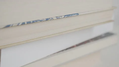 Bookstack on white table 4K shallow DOF video 스톡 동영상 149283776