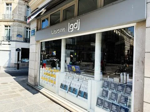 Bookstore Librairie LGDJ window display on a Paris France street with books.. Stock Photos