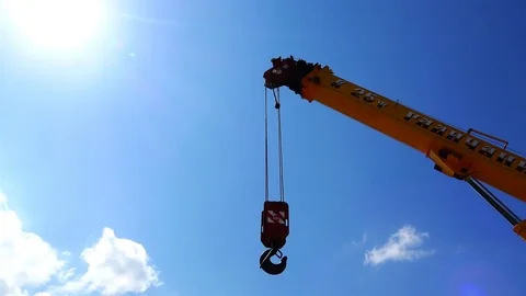 The boom of the crane lowers the winch with the hook for lifting the load Stock Footage 80471488