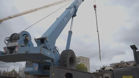 Boom of crane standing on construction site area goes into sky Видео 290505558
