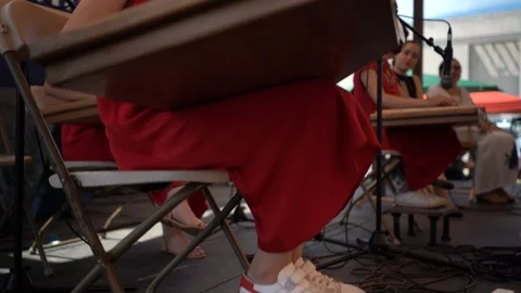 Boom up from ground to settle on one member of the Nor Qanon ensemble when Stock Footage 92602688