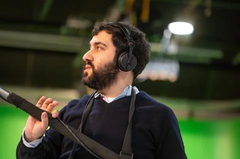 Boom microphone operator testing sound at TV studio. Stock Photos