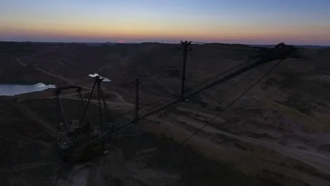 Boom of a walking excavator. Panorama. Sunset. Mine. View from the drone 스톡 동영상 74227524