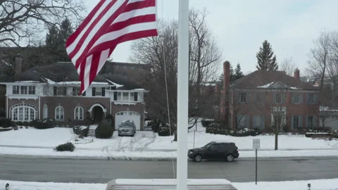 Boom up on war monument with flag at half staff in winter Stock Footage 211188978