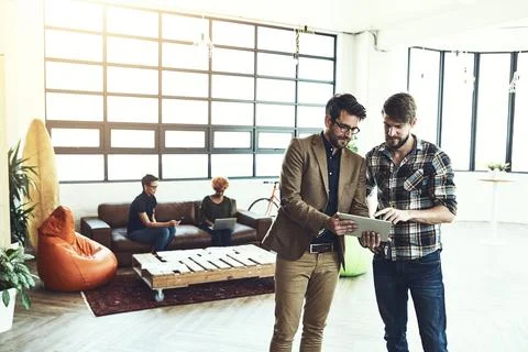 Boost your creativity with technology. two designers discussing something on a Stock Photos