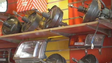 Boosters and head lights for different types of cars on a shelve Stock-Footage 97243369