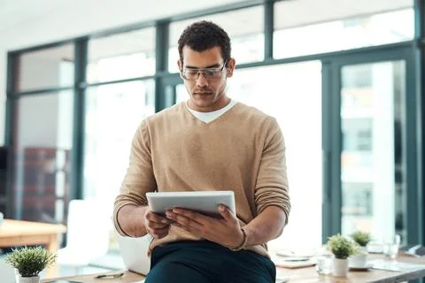 Boosting efficiency in the office. a young designer working on a digital tablet Stock Photos