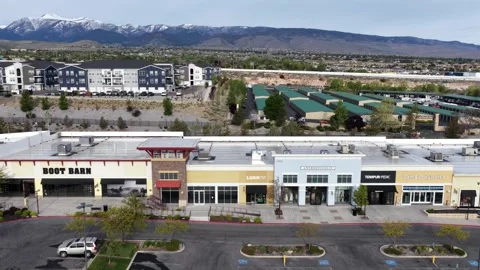Boot Barn, Lush and Tempur-Pedic storefronts line strip mall plaza in Reno Stock Footage 337693456