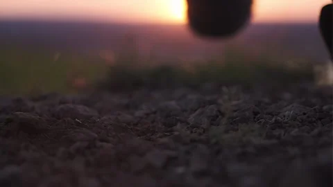 Boot close-up. A man climbs a mountain at sunset Stock Footage 169813647