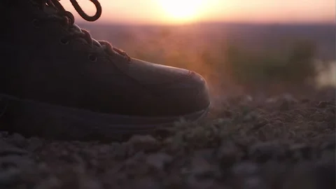 Boot close-up. A man climbs a mountain at sunset Stock Footage 169813698