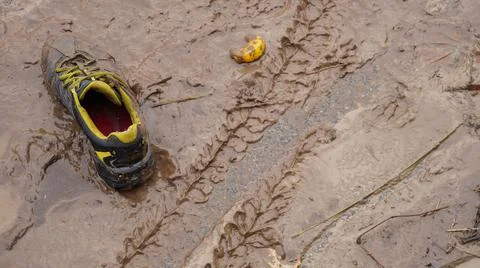 Boot on a dirty brown surface. Stock Photos