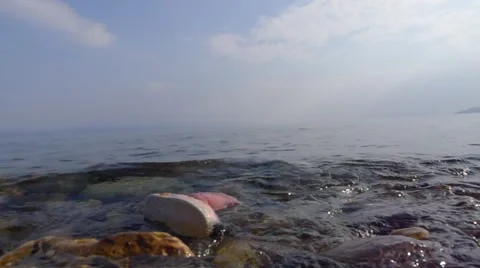 Boot floating in the sea from refugee child Stock Footage 62377421
