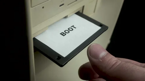 Boot Floppy Disk, Hand Inserting Diskette Into PC Drive, Close Up Stock Footage 175913849