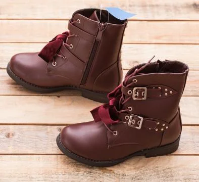 Boot with fur lining at wood background Stock Photos