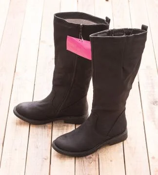 Boot with fur lining at wood background Stock Photos