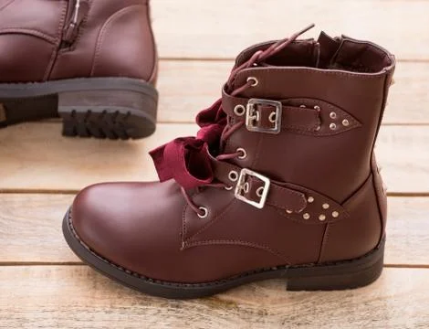 Boot with fur lining at wood background Stock Photos