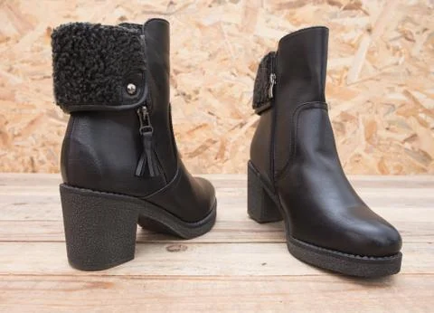 Boot with fur lining at wood background Stock Photos