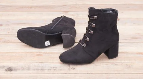 Boot with fur lining at wood background Stock Photos