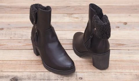 Boot with fur lining at wood background Stock Photos