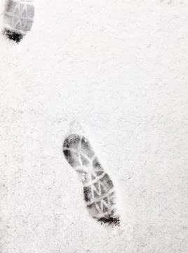 A boot print on the white snow. Stock Photos